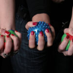 Different girls hands squeezing balls